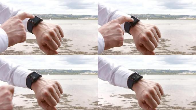 一个男人使用他的智能手表的特写