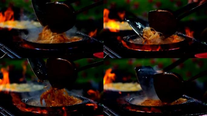 特写厨师烹饪垫泰国炒虾米粉的慢动作镜头
