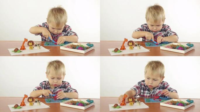 男孩用橡皮泥雕刻