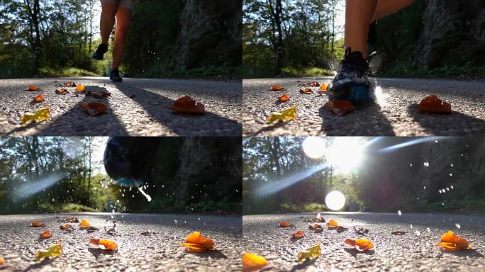 慢动作，镜头耀斑: 年轻女子跑过时踩在落叶上。