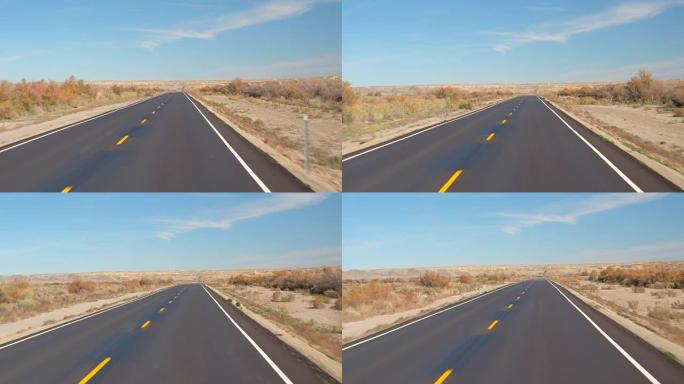 FPV: 在美国犹他州秋天，沿着空旷的道路穿越广阔的沙质沙漠