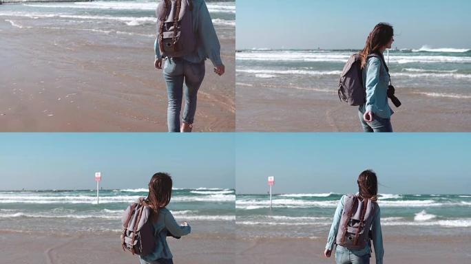 女孩沿着海边散步，在水中扔石头。自由概念。风吹进头发。享受假期。慢动作