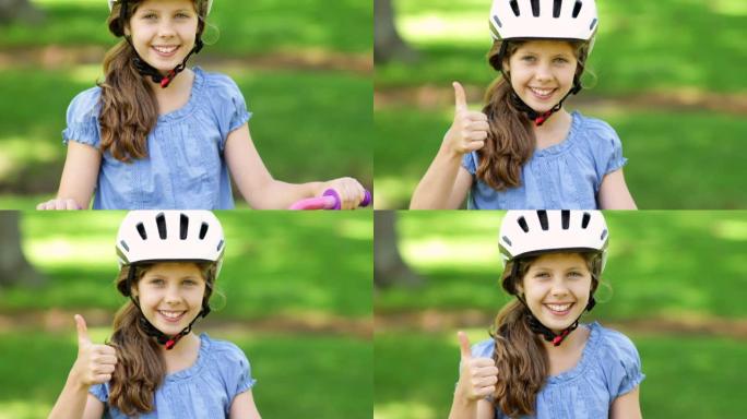 小女孩骑着粉红色的自行车对着镜头微笑