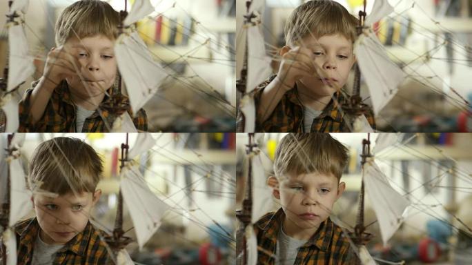 可爱的男孩整理船模型
