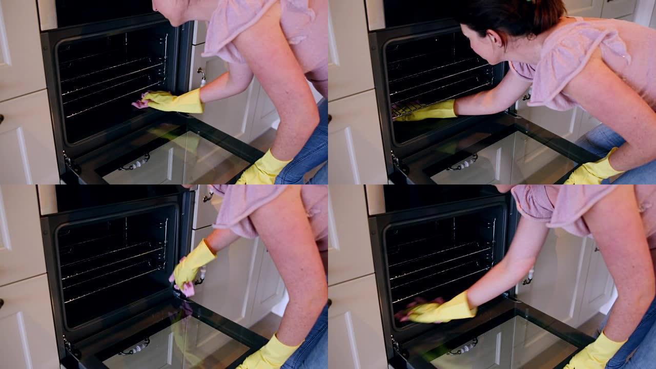 女人清洁烤箱