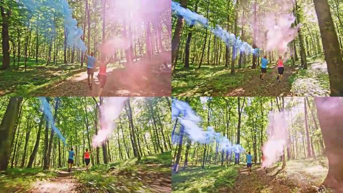 SLO MO TS夫妇带着蓝色和红色的烟雾在森林中奔跑