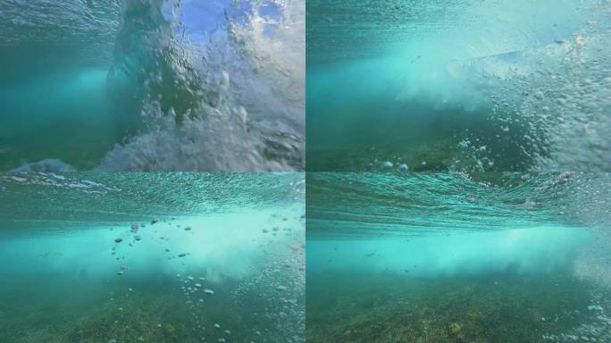 慢动作水下桶波破碎并形成泡沫和气泡。
