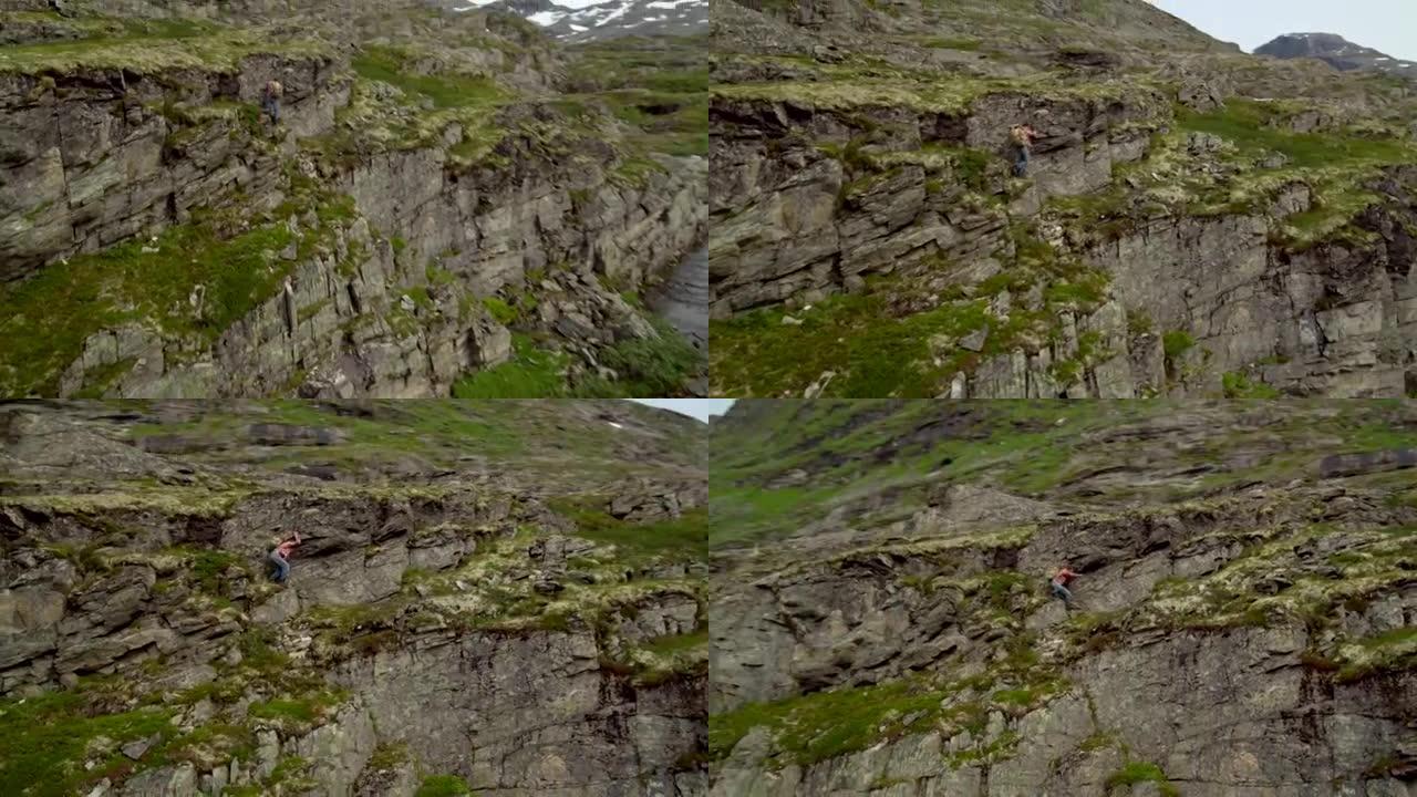 人在垂直的岩石上攀爬。极限训练。无人机的观点
