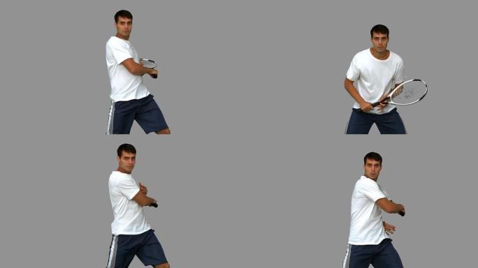 男子在灰色屏幕上打网球时训练