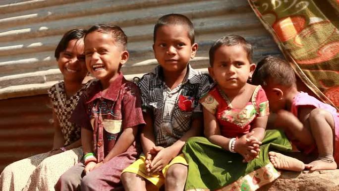 一群兴高采烈的印度农村孩子对着镜头挥手