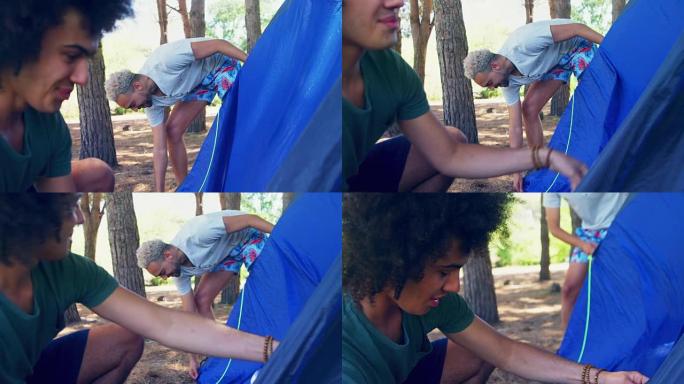 两个男性朋友在公园4k搭帐篷