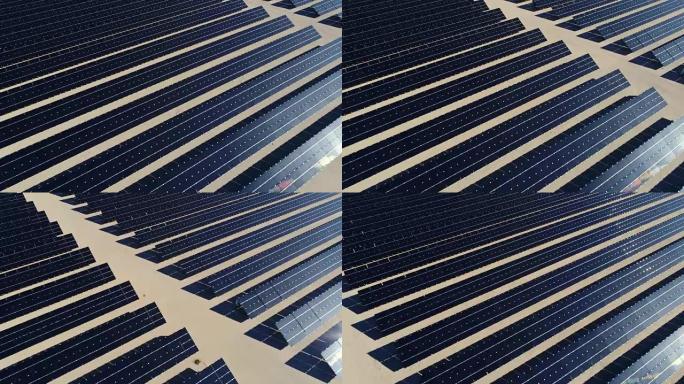 鸟瞰图飞越沙漠中的大型太阳能农场，创造清洁的可再生能源