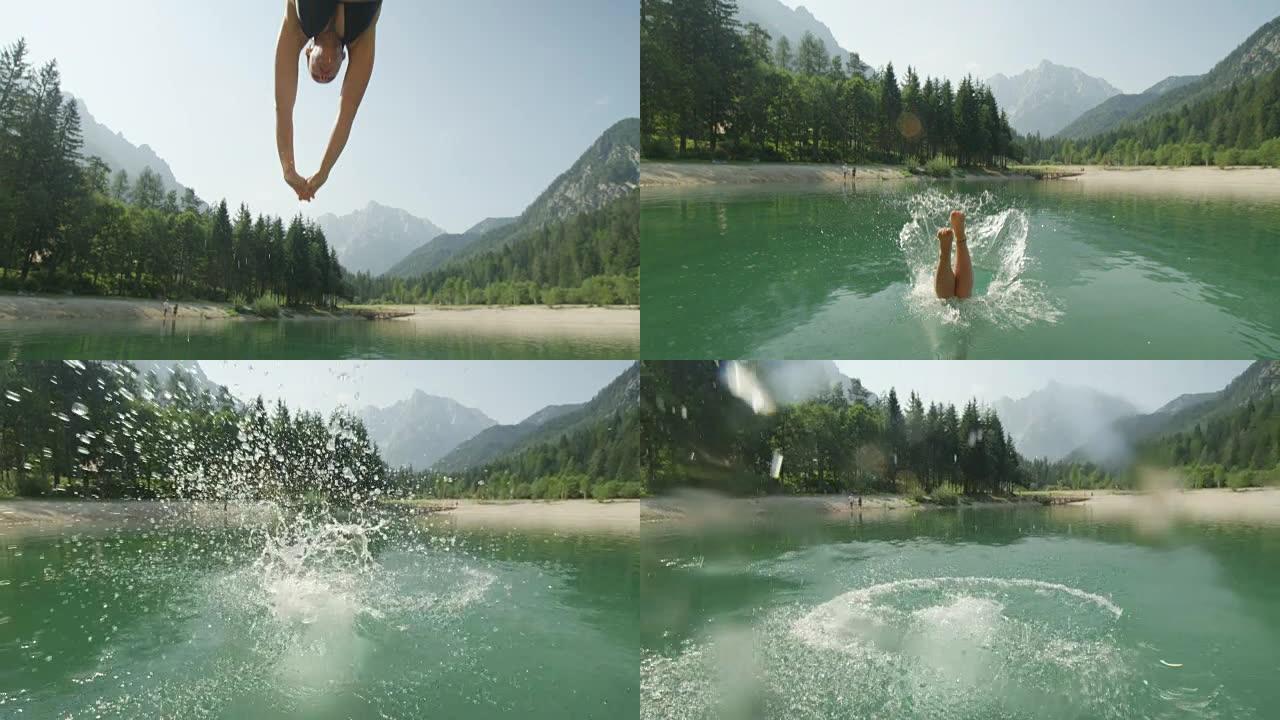 慢动作特写: 穿着比基尼的年轻黑发女人跳过相机，在阳光明媚的夏天潜入美丽的山湖