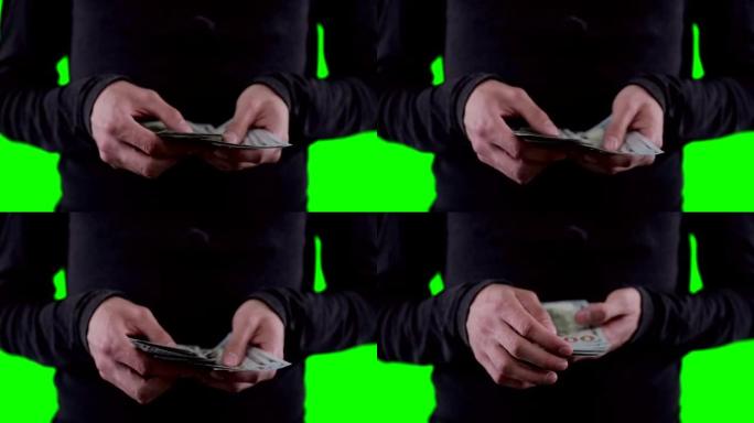 一个面目全非的人手里拿着钱，数着钱，在色马基上显示着美元。近距离