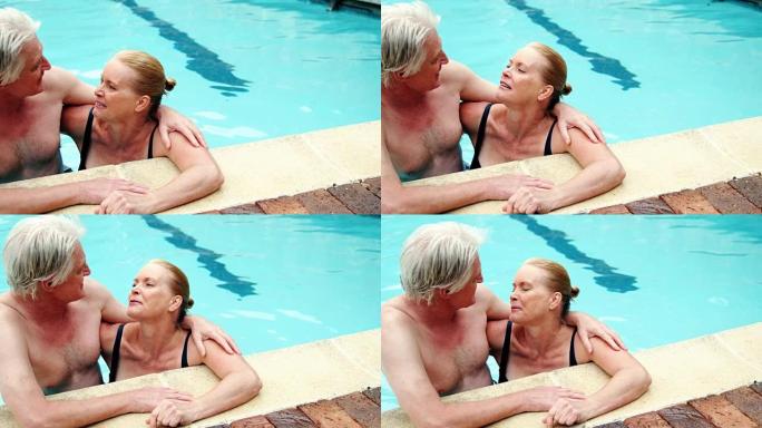 老年夫妇在游泳池拥抱浪漫