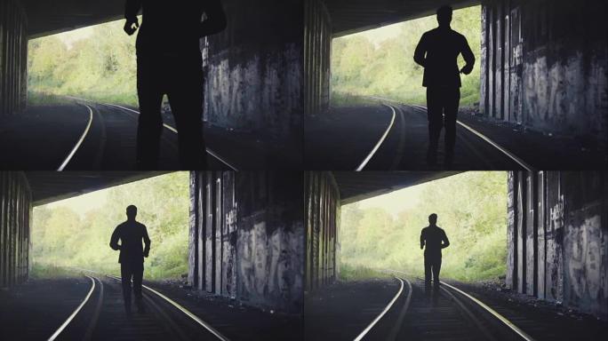 慢动作。迷路的人跑到黑暗隧道出口。后视图。抽象剪影拍摄。逃跑。寻找出路
