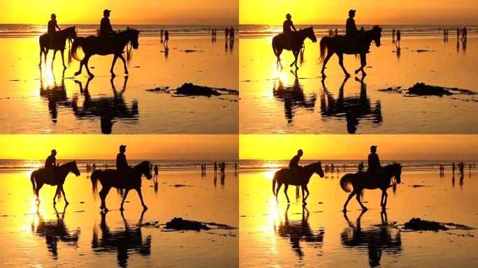 在梦幻般的库塔海滩上的慢动作游客在神奇的金色日落中骑马