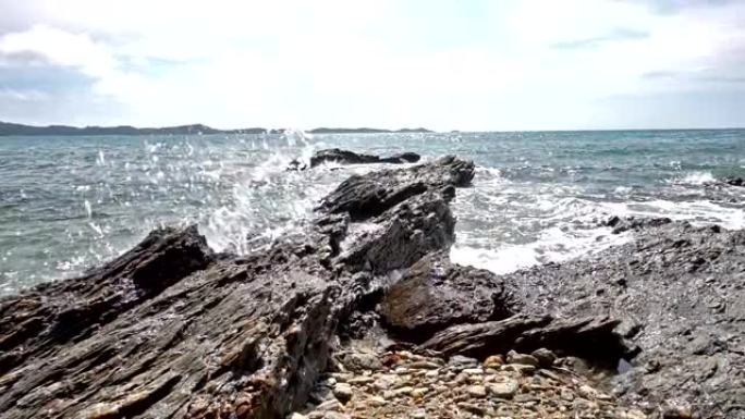 泰国热带海滩海浪撞击岩石海岸线的慢动作