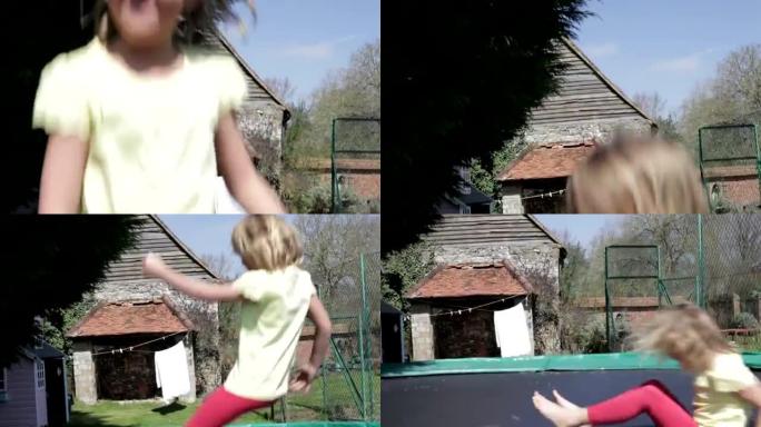 年轻女孩在户外蹦床上蹦蹦跳跳