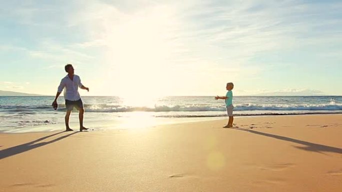 日落时，父子俩一起在海滩玩耍。
