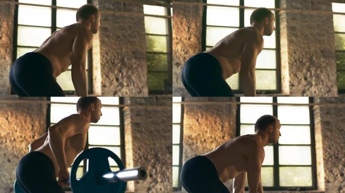 肌肉赤裸的男人吃力地举起沉重的杠铃。他在工业健身房做排长排的弯腰健身操。