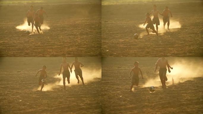 乡村儿童的慢动作在一个村庄的阳光下踢足球。