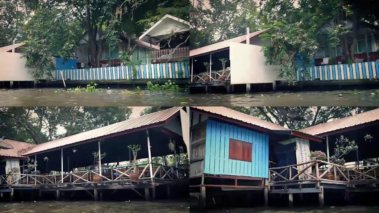 船POV经过热带景观中的河边房屋