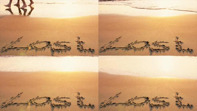 日落时写在海滩上的单词LOST
