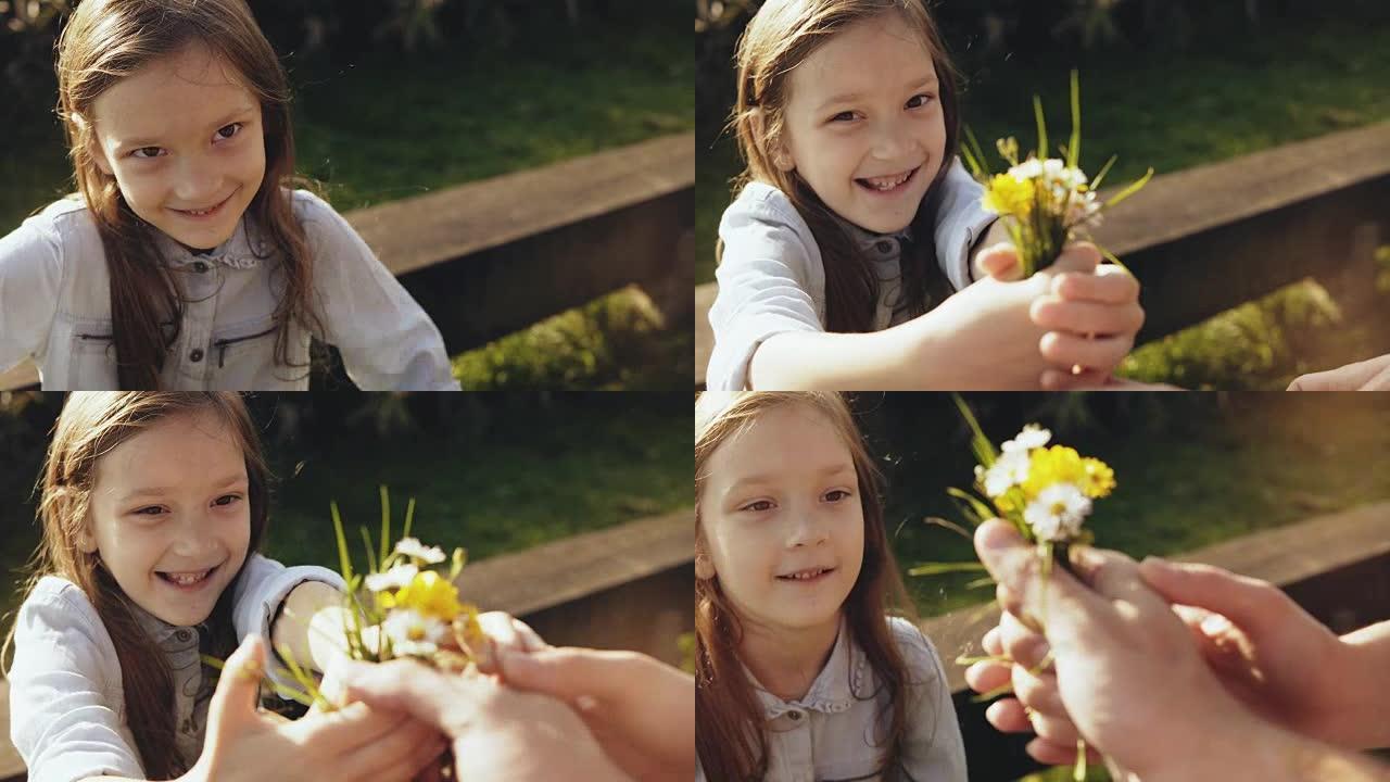 可爱的高加索女孩给父母送花。4K.特写肖像小害羞的孩子。高角度。家庭关系