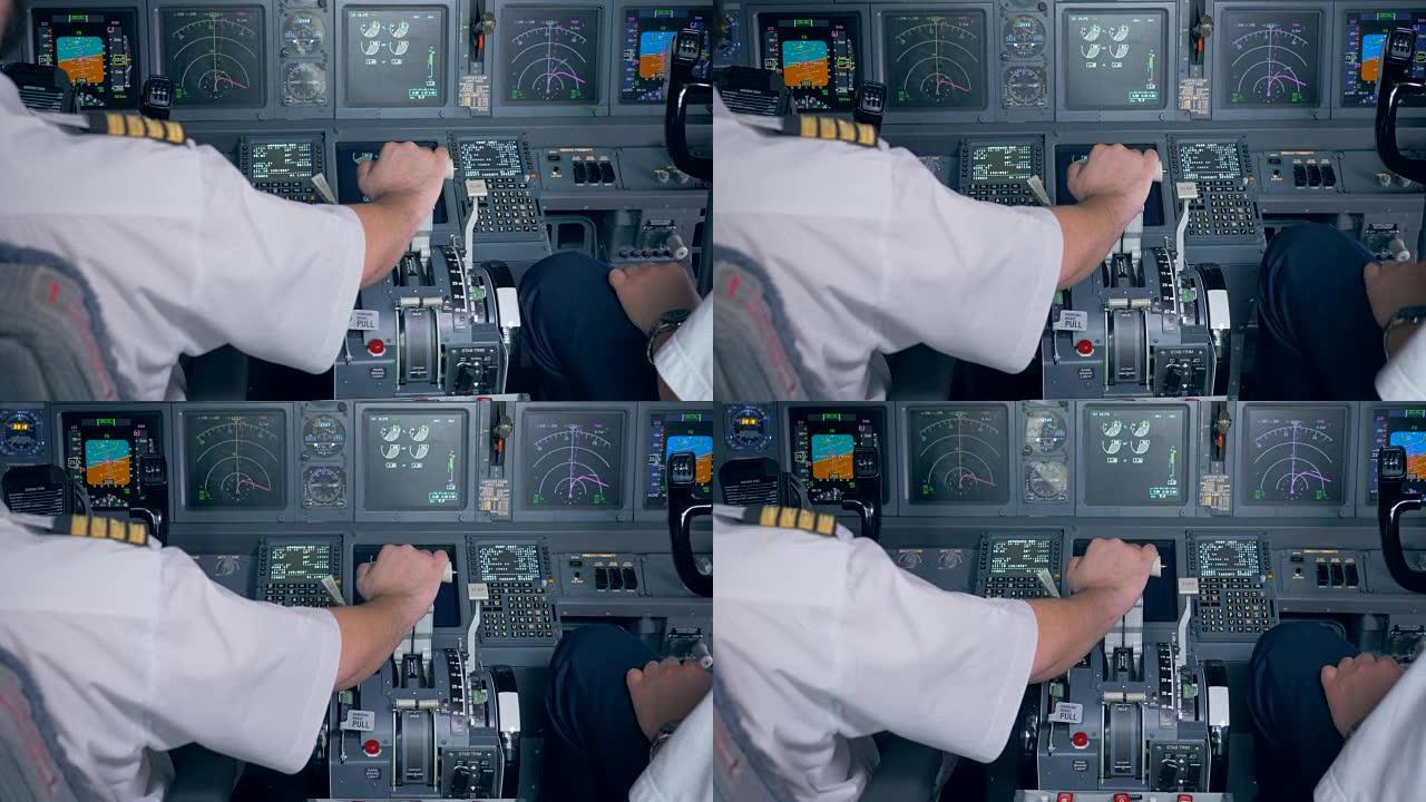飞行员的手位于飞机驾驶舱的油门杆上
