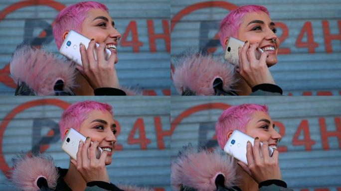 粉红色头发的女人在商店外面用手机说话4k
