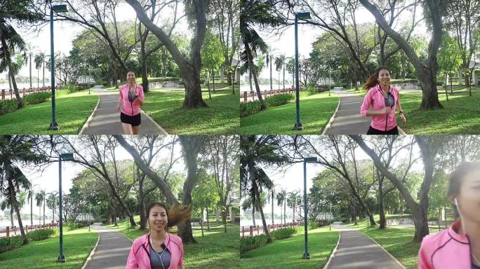慢动作 -- 年轻的亚洲女人早上在人行道上跑步。年轻的体育亚洲女子在公园跑步。健身跑步运动人和健康生