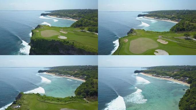空中: 阳光明媚的巴厘岛，悬崖丛生的海岸，泡沫波浪和沙质的巴兰甘海滩