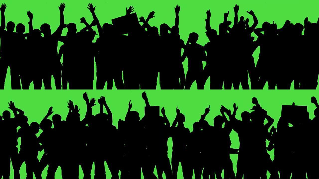 一群粉丝在绿屏上跳舞。音乐会，跳跃，跳舞，举起手来