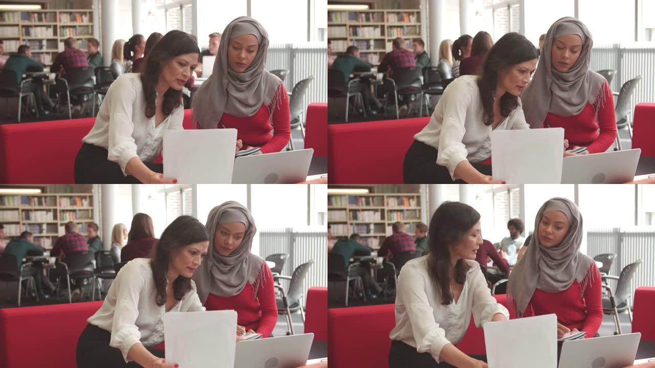 女大学生与导师一起在图书馆工作