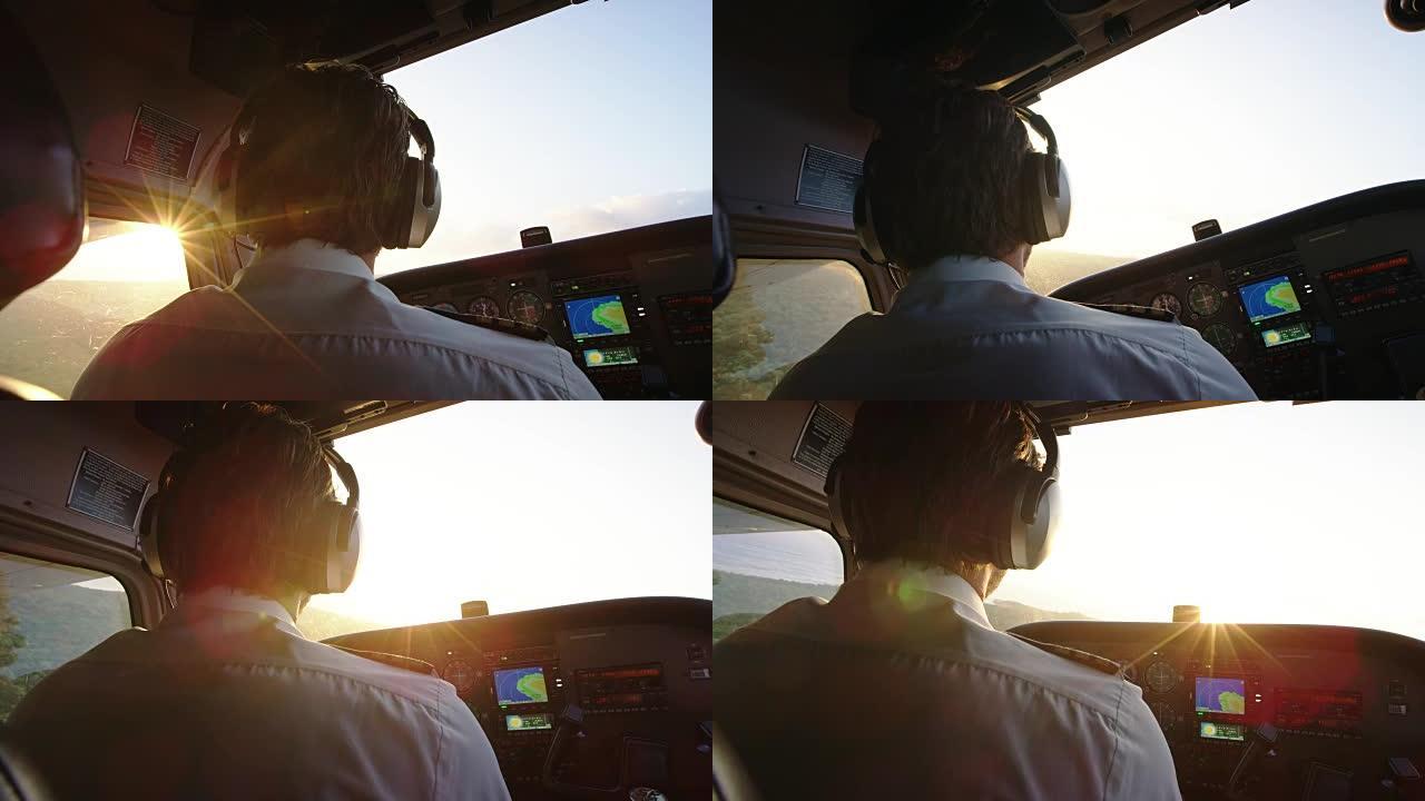 飞行员在日出时驾驶小型飞机。POV驾驶舱视图