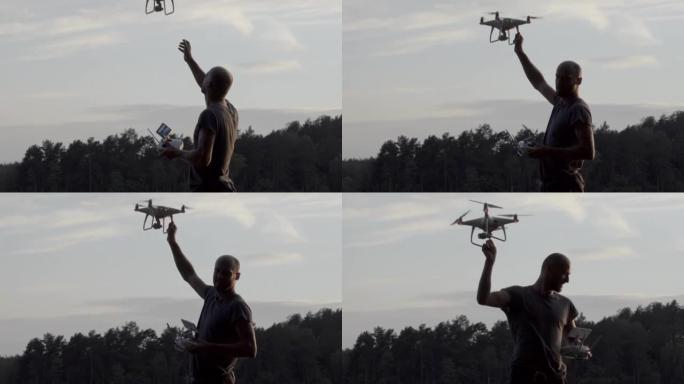 Young man working with drone on a lake coast