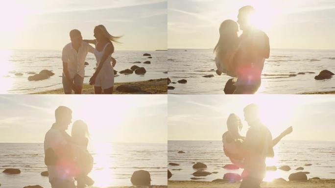 夫妇在海滩上玩得开心。男人怀里抱着女孩，旋转着。