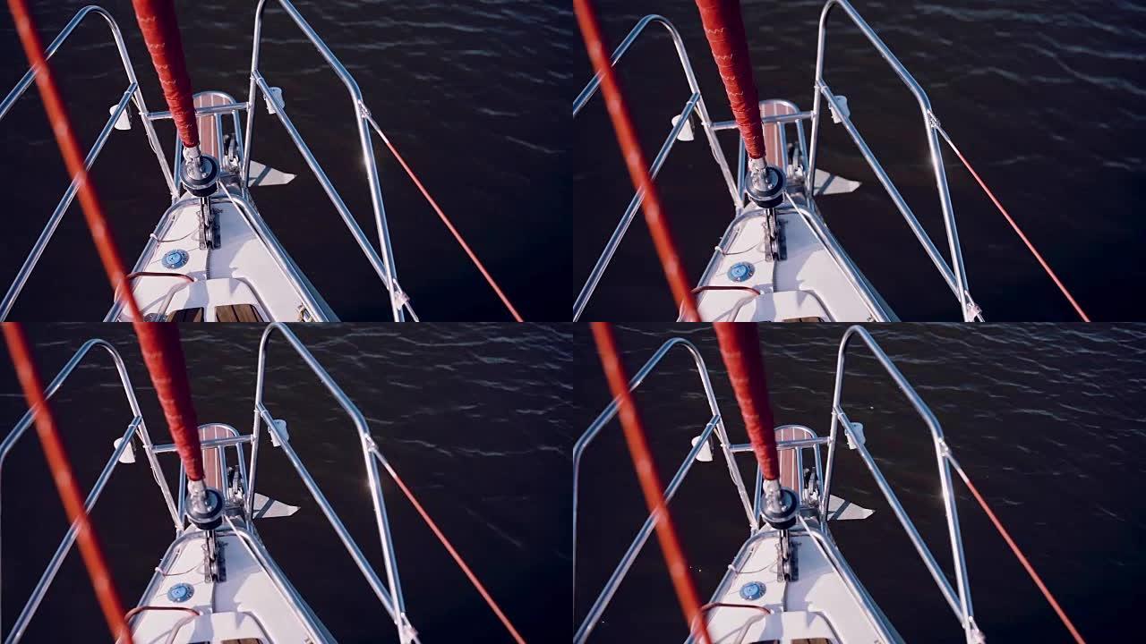 船鼻部的特写视图。帆船在阳光明媚的日子里穿过蓝色的水