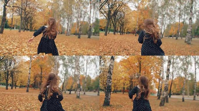 快乐可爱的卷发小女孩，穿着圆点连衣裙，在公园里的秋天小巷里流淌