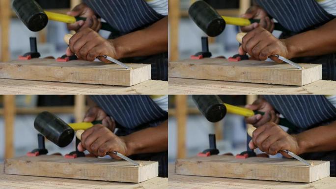木匠用锤子雕刻木材的中段在4k桌