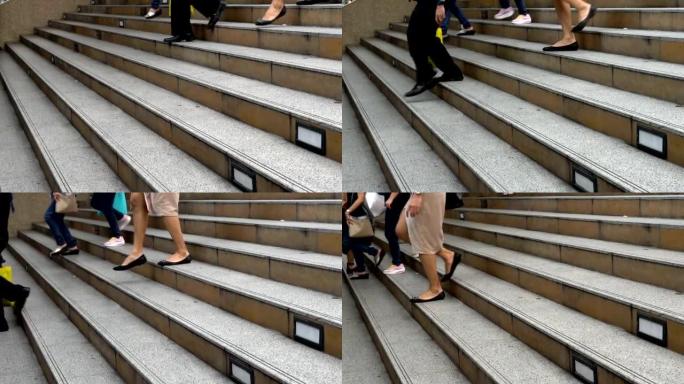 FHD慢动作镜头，人们在市区办公中心楼梯上行走，商业和营销概念