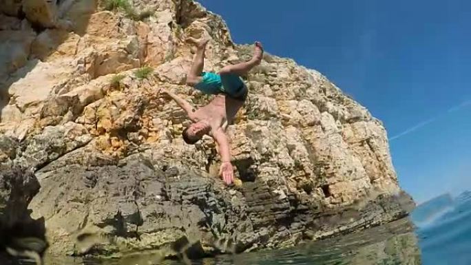 慢动作: 快乐的男人在有趣的暑假里跳进水里