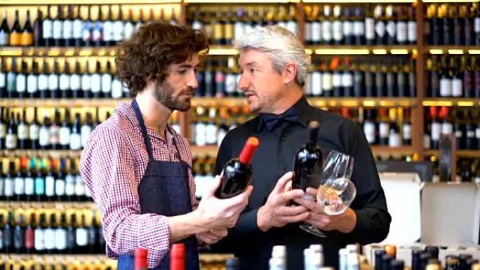 友好的推销员向酒庄的企业主询问有关葡萄酒差异的问题，这两个酒庄看起来都很高兴