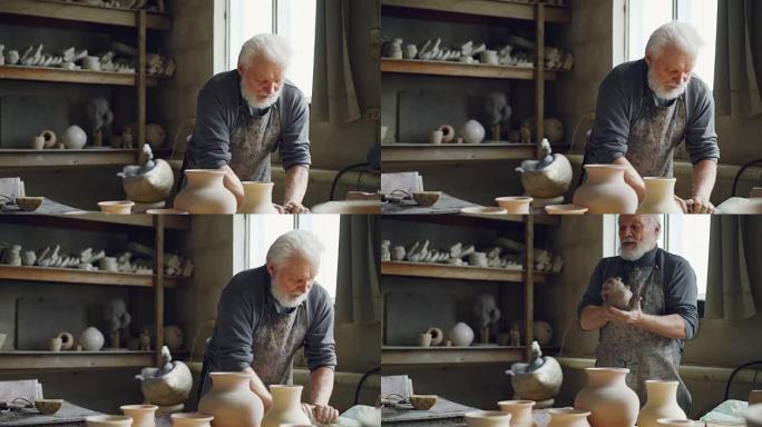 经验丰富的陶工正在车间的工作台上揉捏粘土。创造食道、手工器皿和专业陶器概念。