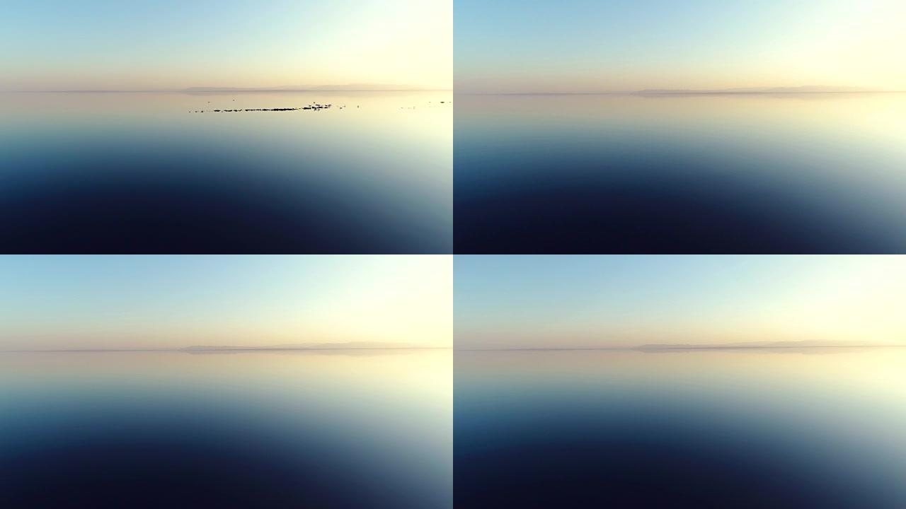日落时湖上水反射的低空鸟瞰图