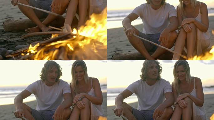 夫妇坐在海滩上着火