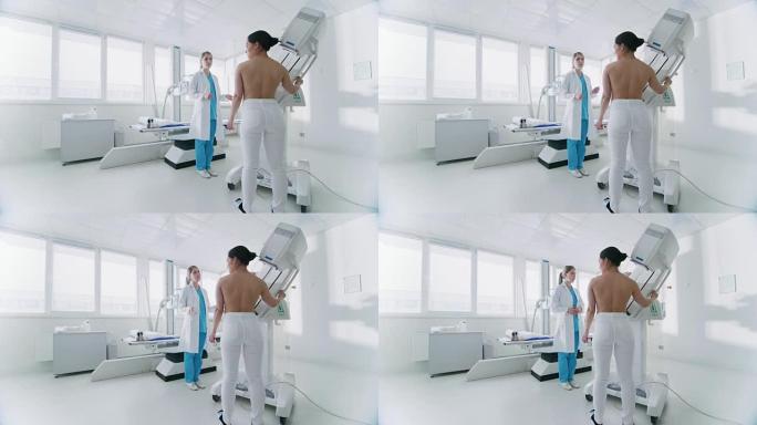 在医院，乳房x线摄影技术专家/医生为女性患者调整乳房x线照相机。友好的医生解释了乳腺癌预防筛查的重要