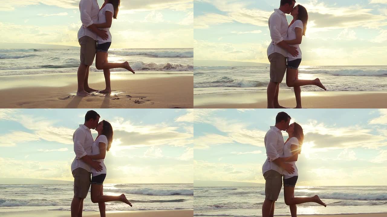 海滩日落时热恋的情侣