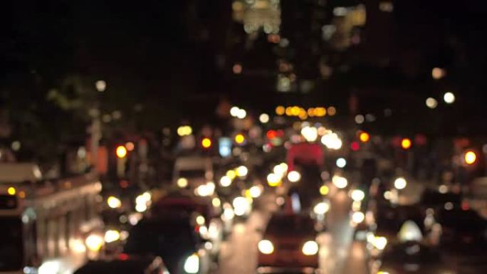 BOKEH: 夜间在繁忙的街道上抽动城市的灯光和模糊的交通信号灯